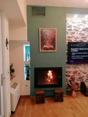 a fireplace in a living room with a fire place at SOKRATESg in Athens