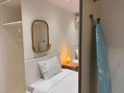 a small bedroom with a bed and a mirror at Cute Detached Home near Glyfada Center in Athens