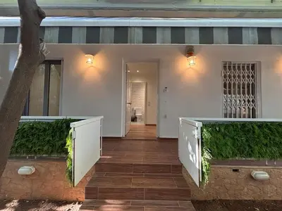 a home with a porch with green plants at Cute Detached Home near Glyfada Center in Athens