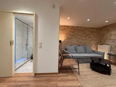 a living room with a bed and a table at Cute Detached Home near Glyfada Center in Athens