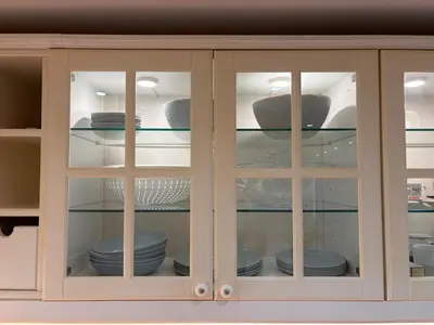 a glass cabinet with plates and dishes in it at Cute Detached Home near Glyfada Center in Athens