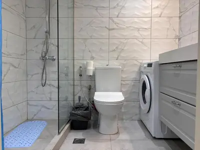 a bathroom with a toilet and a glass shower at Cute Detached Home near Glyfada Center in Athens