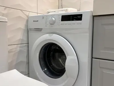 a white washing machine sitting in a kitchen at Cute Detached Home near Glyfada Center in Athens