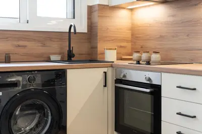 a kitchen with a washing machine and a sink at 1BR Stylish Apt Near Metro, 15' From Acropolis in Athens