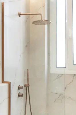 a shower with a shower head in a bathroom at 1BR Stylish Apt Near Metro, 15' From Acropolis in Athens