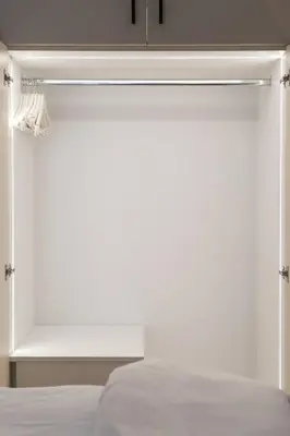 a bedroom with a white bed and a closet at 1BR Stylish Apt Near Metro, 15' From Acropolis in Athens