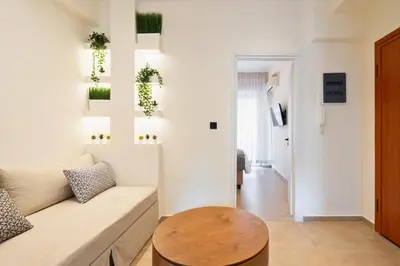 a living room with a couch and a table at 1BR Stylish Apt Near Metro, 15' From Acropolis in Athens