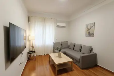 a living room with a couch and a table at Kolonaki Corner -- Bright 2-Bed close to Metro in Athens