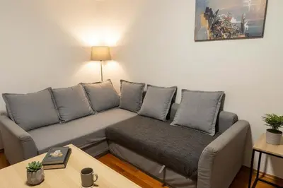 a living room with a couch and a table at Kolonaki Corner -- Bright 2-Bed close to Metro in Athens