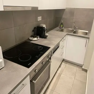 a kitchen with a stove and a sink at Kolonaki Corner -- Bright 2-Bed close to Metro in Athens