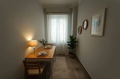 a room with a table with a lamp and a window at Kolonaki Corner -- Bright 2-Bed close to Metro in Athens