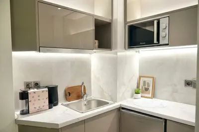 a kitchen with a sink and a microwave at The Perch Kolonaki Square Studio Prime Location in Athens