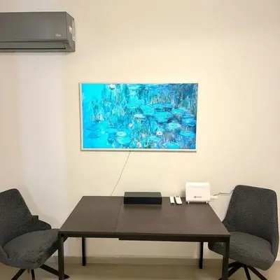 a table with two chairs and a painting on the wall at The Perch Kolonaki Square Studio Prime Location in Athens
