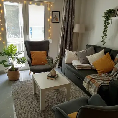 a living room with a couch and a table at Your Cozy Corner in Central Kypseli in Athens