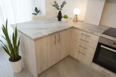 a kitchen with a marble counter top and a stove at Your Cozy Corner in Central Kypseli in Athens