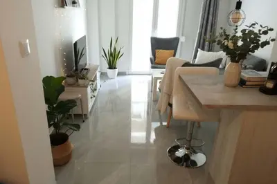 a living room with a table and some plants at Your Cozy Corner in Central Kypseli in Athens