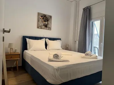 a bedroom with a bed with towels on it at A&C Urban Elegance in Athens