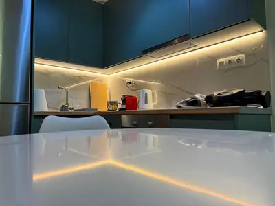a kitchen with a white table and blue cabinets at A&C Urban Elegance in Athens