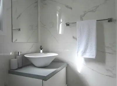 a white bathroom with a sink and a mirror at Walk to Acropolis of Athens,15-min Metro nearby in Athens