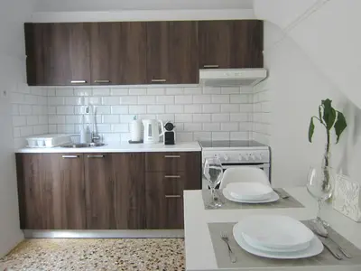 a kitchen with a counter with a sink and a stove at Walk to Acropolis of Athens,15-min Metro nearby in Athens