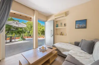 a living room with a couch and a table at Cozy Loft Vouliagmeni in Athens
