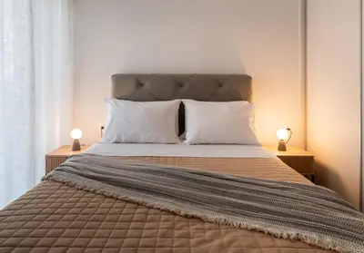 a bedroom with a large bed with white pillows at Elvita Apartments 5 in Athens