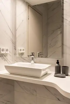 a bathroom with a white sink and a mirror at Elvita Apartments 5 in Athens