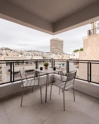 a table and chairs on a balcony with a view at Elvita Apartments 5 in Athens