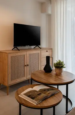 a living room with a tv and a table at Elvita Apartments 5 in Athens