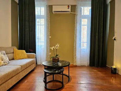 a living room with a couch and a table at Leon Filoxenia in Athens
