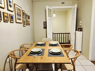 a dining room with a wooden table and chairs at Leon Filoxenia in Athens