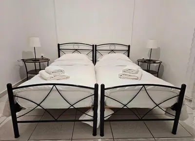 a black and white bed with white pillows on it at Leon Filoxenia in Athens