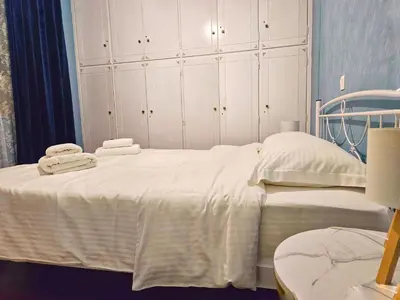 a bed with white sheets and towels on it at Leon Filoxenia in Athens