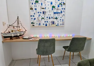 a desk with two chairs and a toy boat on it at Leon Filoxenia in Athens
