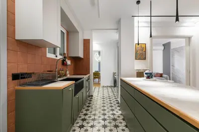 a kitchen with green cabinets and a tile floor at Elysia - Crafted 2-Bedroom Apt & Balcony in Athens in Athens