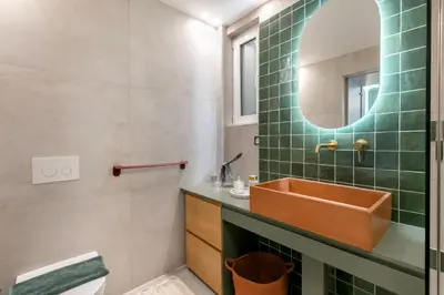 a bathroom with a sink and a mirror at Elysia - Crafted 2-Bedroom Apt & Balcony in Athens in Athens