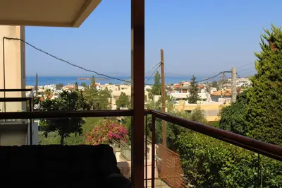 a balcony with a view of a city and the ocean at SERENE Riviera Apartment by Anastassiadis Hospitality in Athens