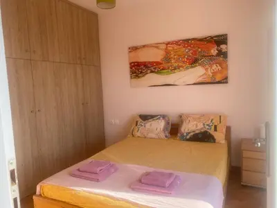 a bedroom with a bed with two towels on it at In the heart of Athens overlooking Kalligas Square! in Athens