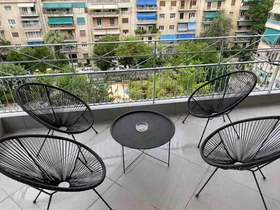 a balcony with three chairs and a table on a balcony at In the heart of Athens overlooking Kalligas Square! in Athens