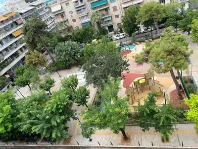 an overhead view of a park with trees and benches at In the heart of Athens overlooking Kalligas Square! in Athens