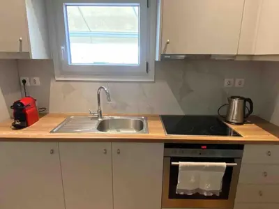 a kitchen with a sink and a stove and a window at In the heart of Athens overlooking Kalligas Square! in Athens