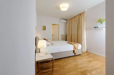 a bedroom with a bed and a table with a lamp at Athens Anasses Luxury Apartments in Athens
