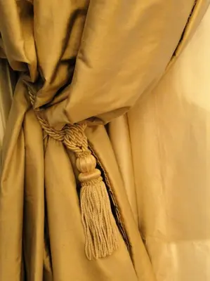 a close up of a tan curtain with a tassel at Athens Anasses Luxury Apartments in Athens