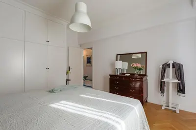 a bedroom with a bed and a dresser and a mirror at Athens Anasses Luxury Apartments in Athens