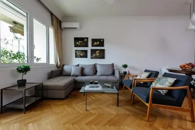 a living room with a couch and a table at Athens Anasses Luxury Apartments in Athens