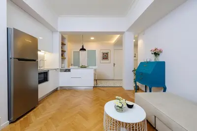 a kitchen and a living room with a couch and a table at Athens Anasses Luxury Apartments in Athens