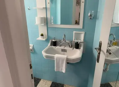a blue bathroom with a sink and a mirror at Your Piraeus Escape Cozy One-Bedroom Apartment in Piraeus