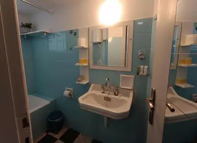 a bathroom with a sink and a mirror and a tub at Your Piraeus Escape Cozy One-Bedroom Apartment in Piraeus