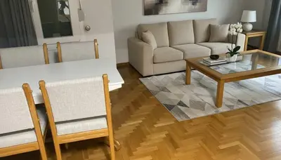 a living room with a couch and a table at Athens Central Gem 2-Bedroom Retreat in Athens
