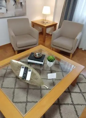 a living room with two chairs and a coffee table at Athens Central Gem 2-Bedroom Retreat in Athens